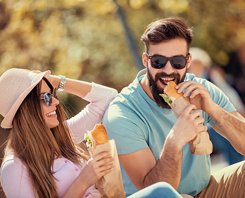 Happy Couple Eating Subs